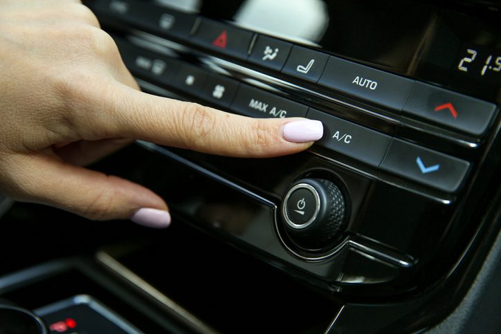 turning on or turning off the air conditioner in the car close up. pushing a/c button inside car